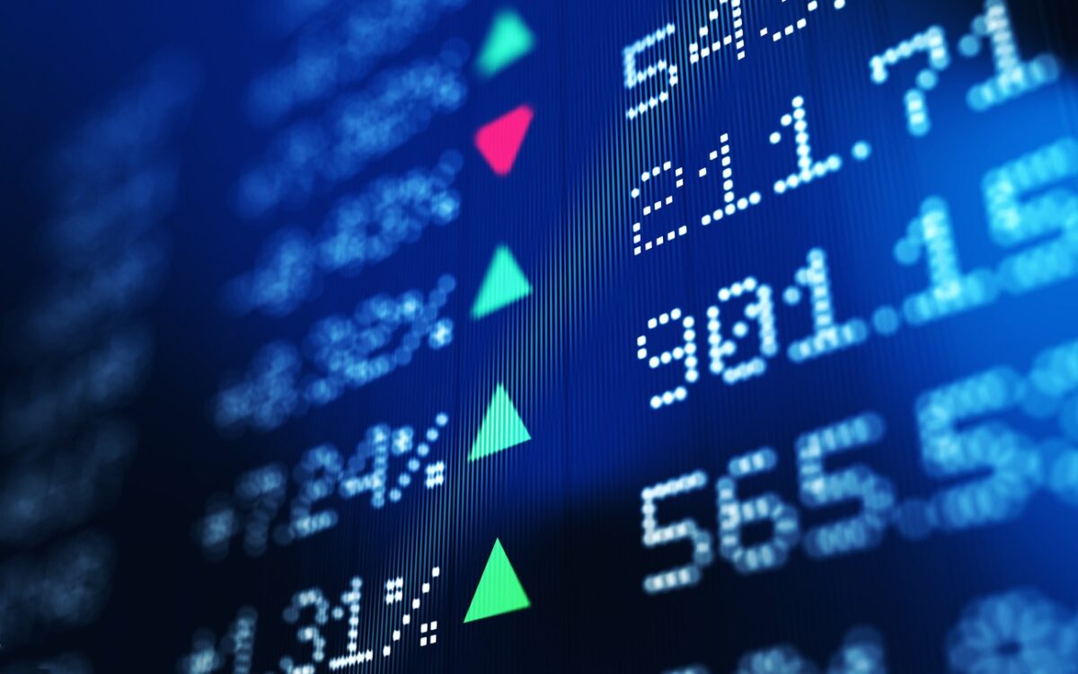 Financial data analysis graph showing stock market trends on a trading board. Horizontal composition with copy space and selective focus.