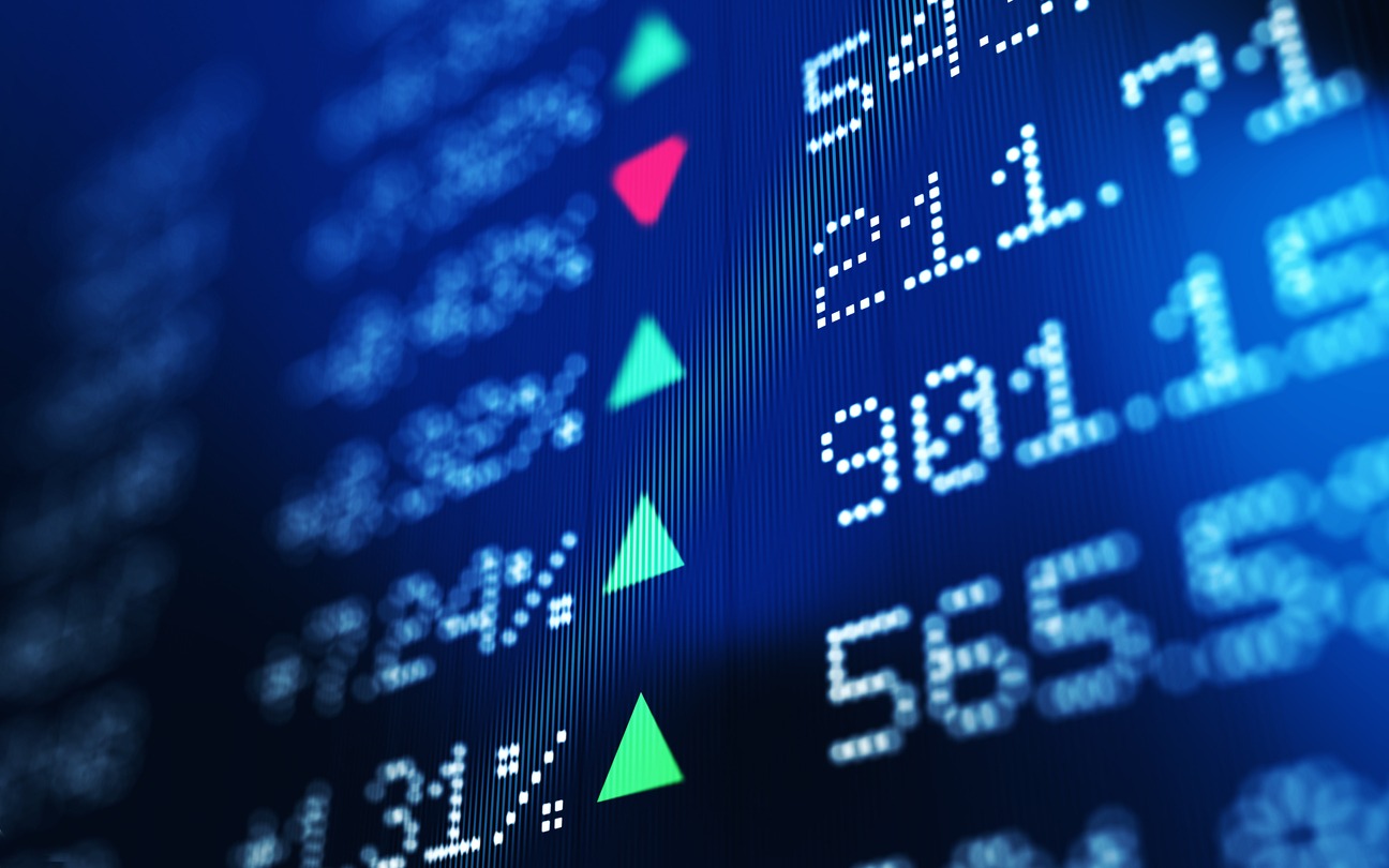 Financial data analysis graph showing stock market trends on a trading board. Horizontal composition with copy space and selective focus.