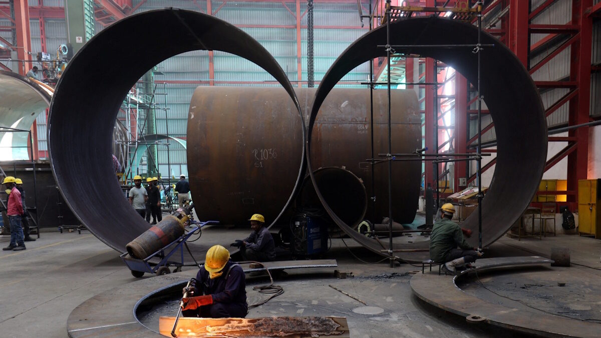 A worker cuts a metal plate inside an industrial tank manufacturing factory on the outskirts of Ahmedabad, India, January 31, 2025.