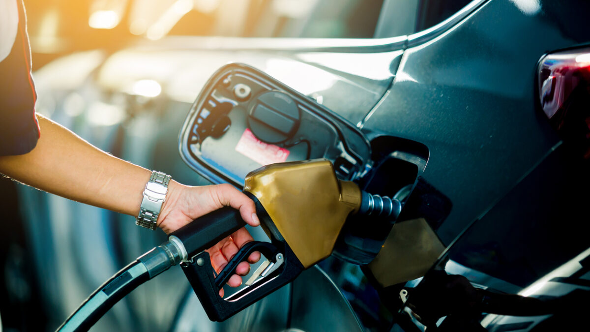Hand refilling the car with fuel at the refuel station
