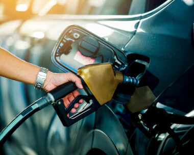 Hand refilling the car with fuel at the refuel station