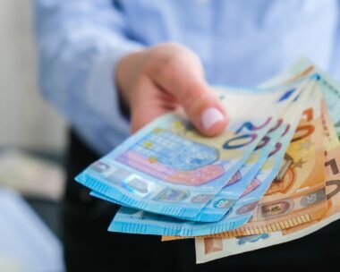 Business Woman Displaying a Spread of Cash euros. Close-up. Income and Business concept. Venality, bribe, corruption concept. Hand giving money. Millennial candid authentic female hands counting money. Business budget of wealth and prosperity finance