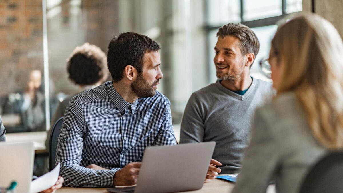 Mid adult businessmen talking while working in the office
