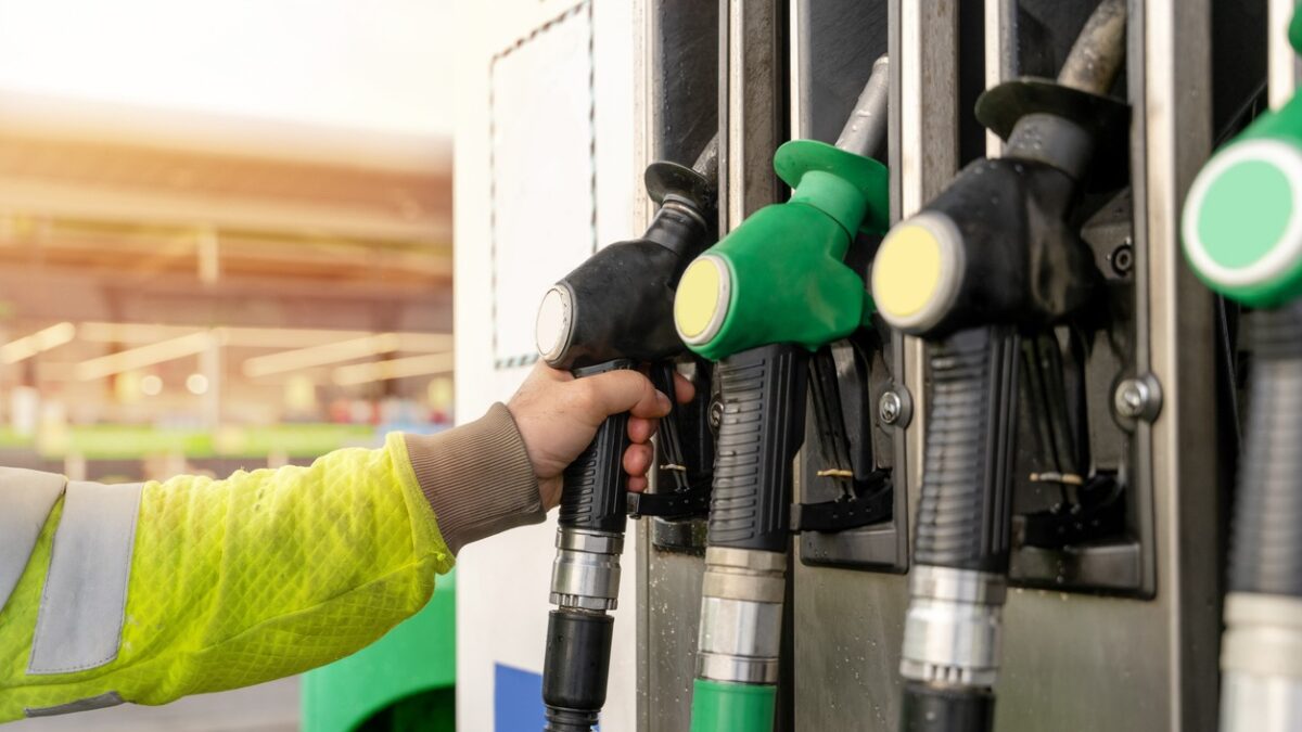 Colorful petrol and diesel nozzles of the dispenser machine at the gas fuel station