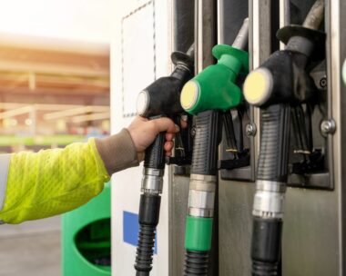 Colorful petrol and diesel nozzles of the dispenser machine at the gas fuel station