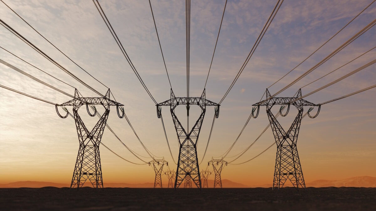 The silhouette of the high voltage power lines during sunset