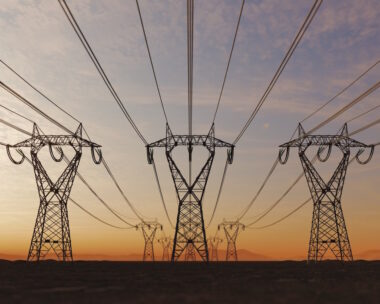 The silhouette of the high voltage power lines during sunset