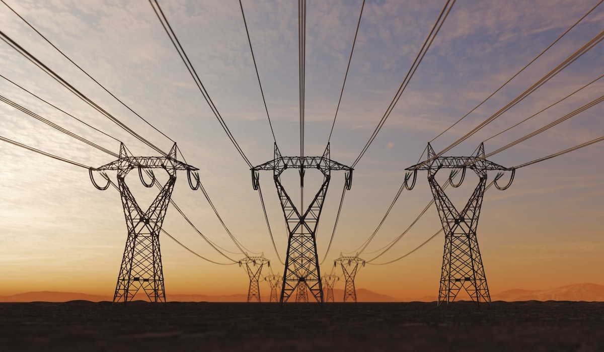 The silhouette of the high voltage power lines during sunset