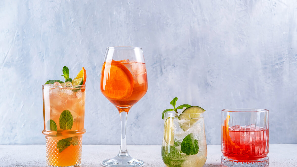 Various alcoholic cocktails on grey background. Spritz, Mojito, Negroni. Summer cocktails menu. Summer alcoholic cocktails for party.