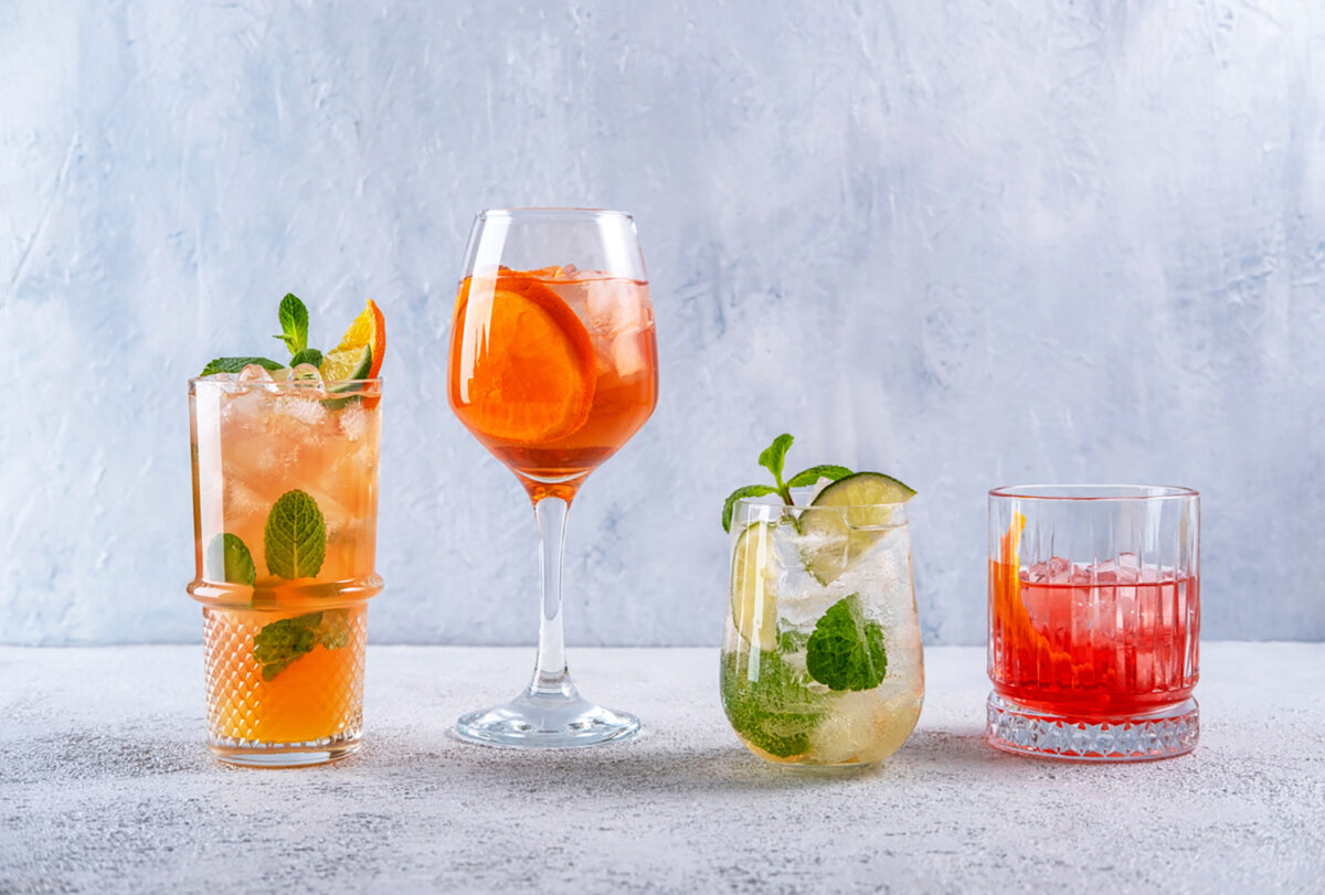 Various alcoholic cocktails on grey background. Spritz, Mojito, Negroni. Summer cocktails menu. Summer alcoholic cocktails for party.