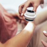 The dermatologist examines the moles or acne of the patient with a dermatoscope. Prevention of melanoma