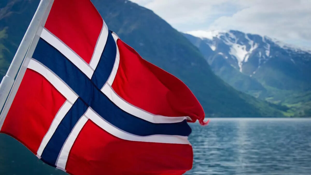 Norwegian flag on the back of a ferry cruising the fjords