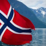 Norwegian flag on the back of a ferry cruising the fjords