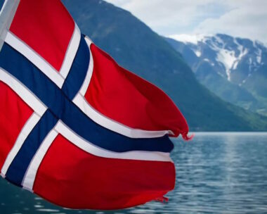 Norwegian flag on the back of a ferry cruising the fjords