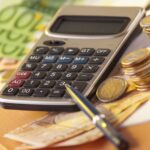 European money on a table with calculator and coins, money and banking concept