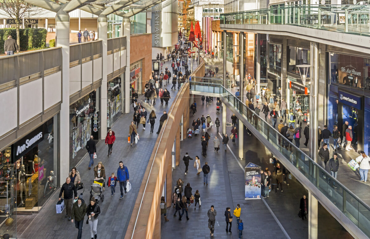 View of a busy shopping street in the centre of Liverpool, UK Shops can be seen on either side of the photograph and people can be seen walking on the pavements