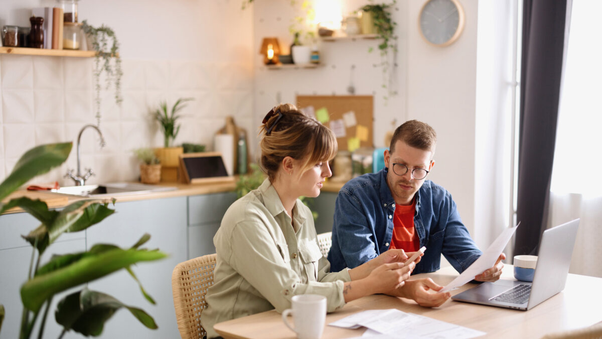 Young man and woman paying bills from home