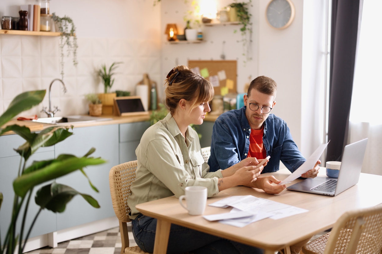 Young man and woman paying bills from home