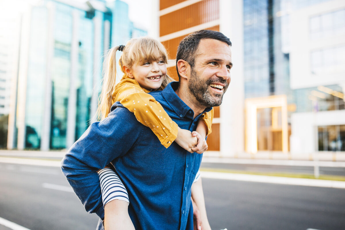 Father and daughter bonding and having fun in the city center.