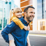 Father and daughter bonding and having fun in the city center.