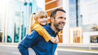 Father and daughter bonding and having fun in the city center.