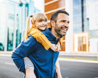 Father and daughter bonding and having fun in the city center.