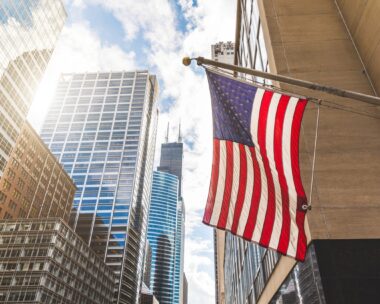 USA flag in Chicago with with skyscrapers on background