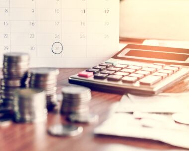 debt collection and tax season concept with deadline calendar remind note,coins,banks,calculator on table, background ,time to pay concept