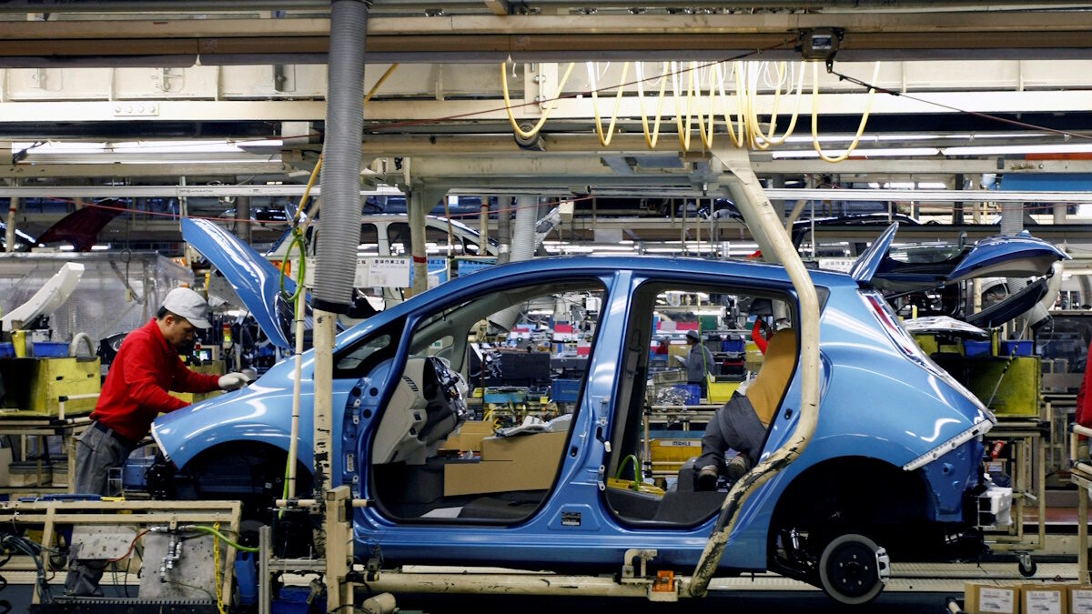 An employee of Nissan Motor works on its Leaf electric car on an assembly line at Oppama plant, in Yokosuka, south of Tokyo January 25, 2011.