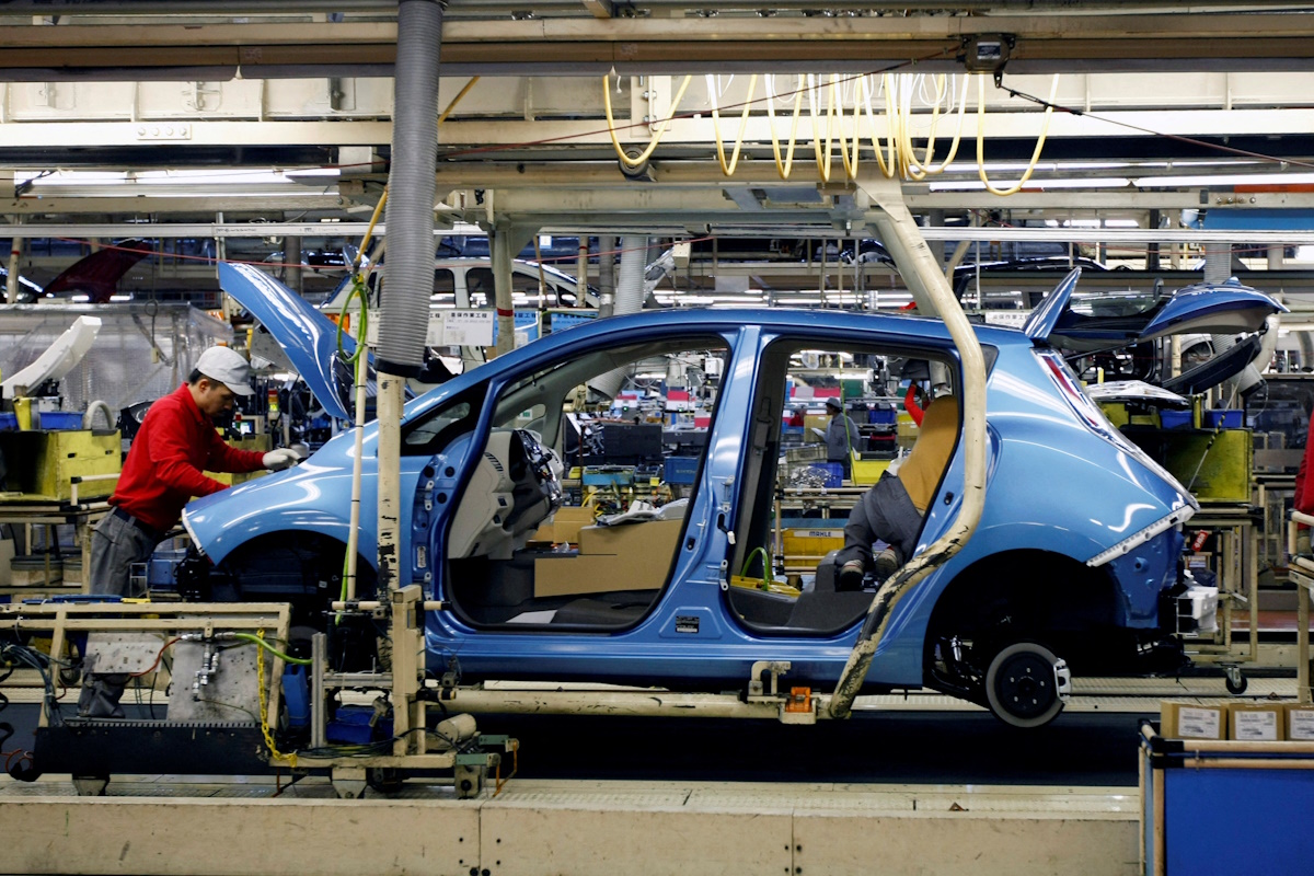 An employee of Nissan Motor works on its Leaf electric car on an assembly line at Oppama plant, in Yokosuka, south of Tokyo January 25, 2011.