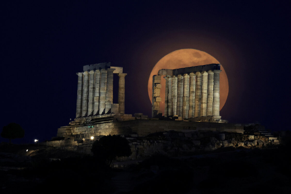 The full moon, known as a "Flower Moon" rises behind the Temple of Poseidon in Cape Sounion, near Athens, Greece, May 12, 2025. REUTERS/Louisa Gouliamaki