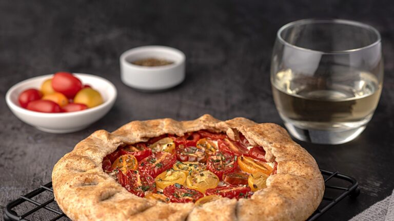 Food photography of galette with tomatoes and ricotta; white wine, seasoning, whole wheat flour; savoury pastry, shortcrust pastry