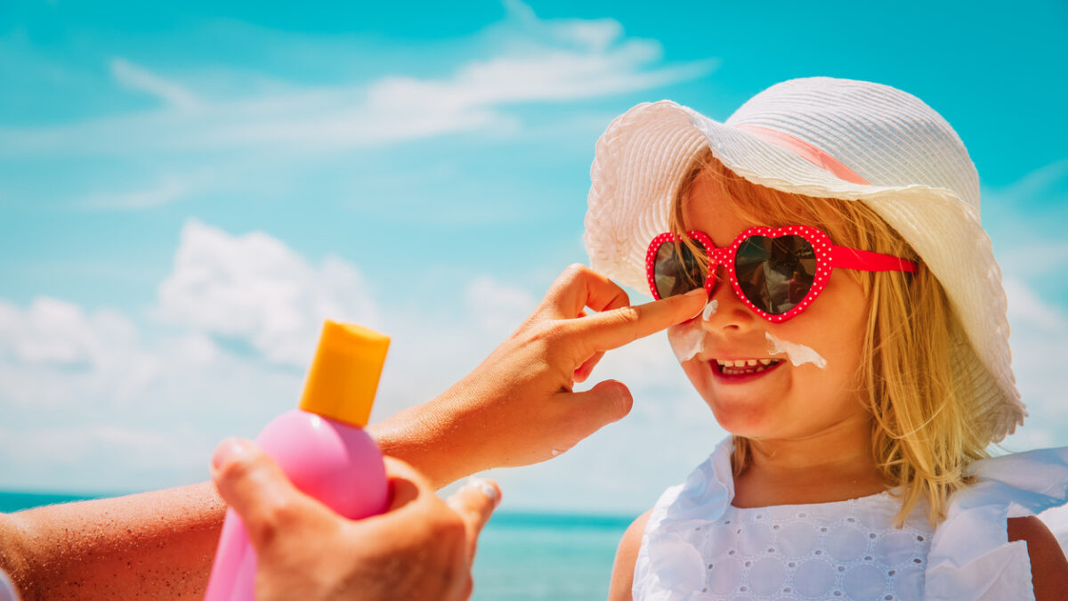 sun protection - mother put sunblock cream on little daughter face