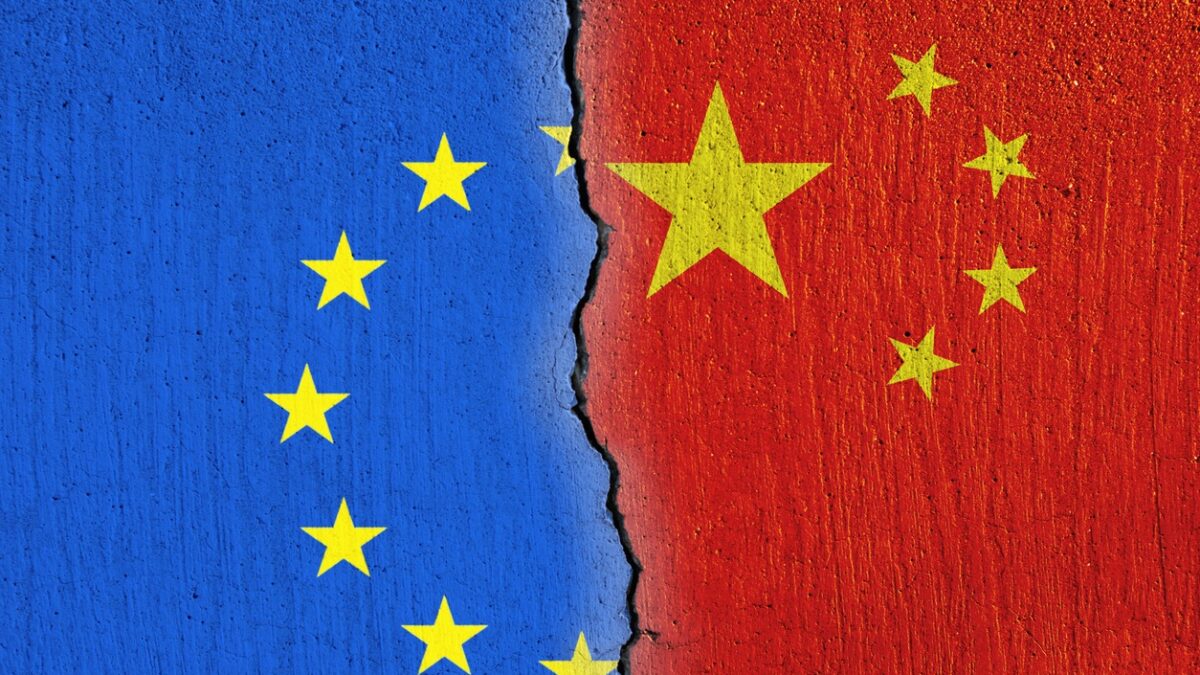 European Union flag and Chinese flag painted on cracked wall