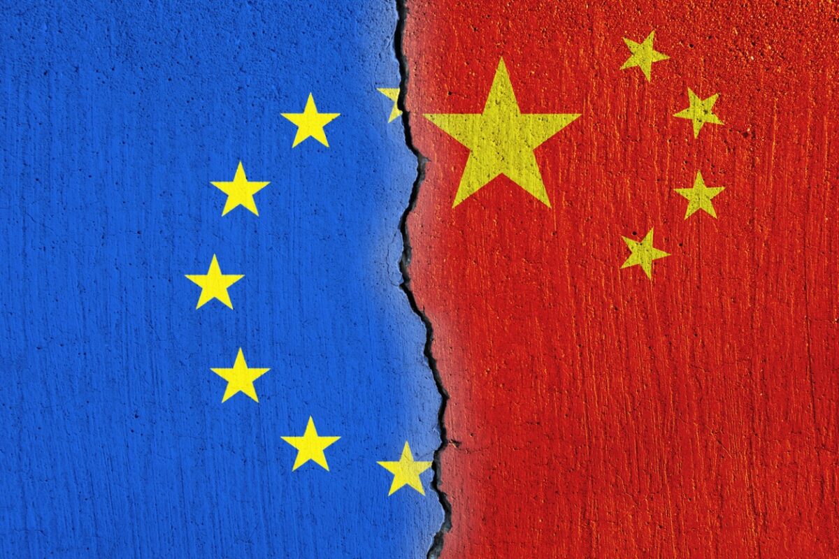 European Union flag and Chinese flag painted on cracked wall