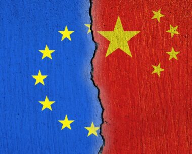 European Union flag and Chinese flag painted on cracked wall