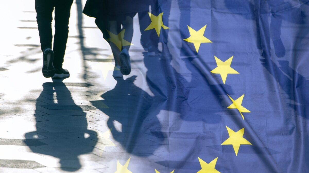 EU or European Union Flag and shadows of people, concept political picture