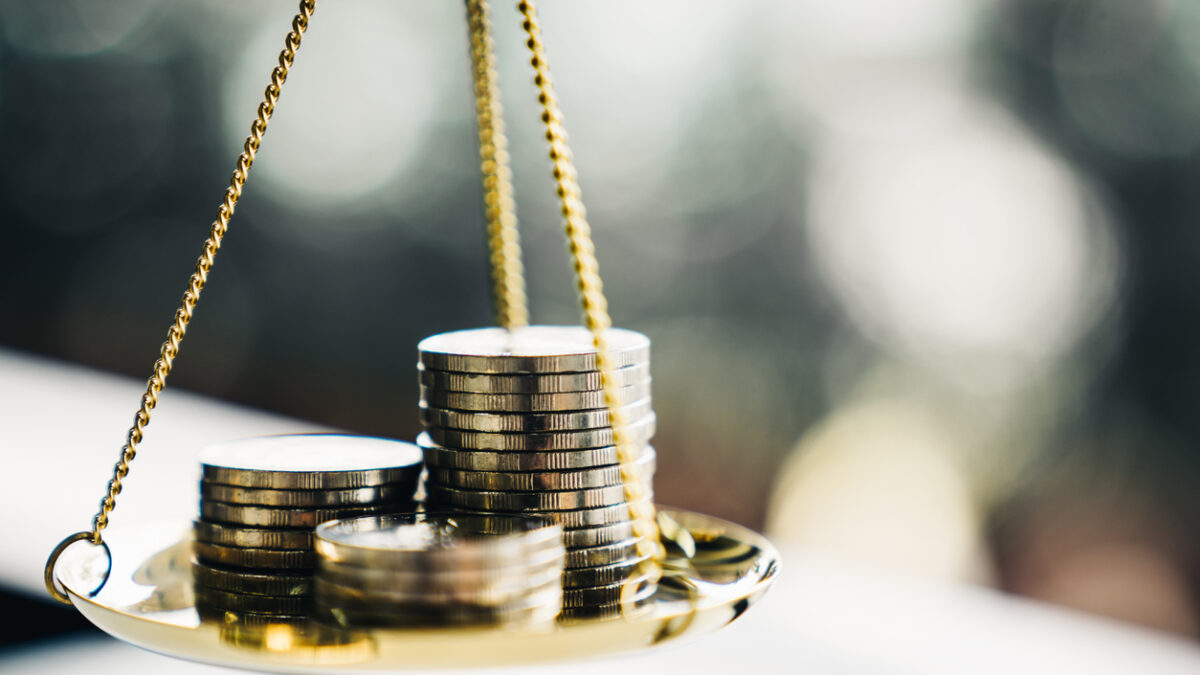 Coins stack with balance scale. Money management, financial plan, time value of money, business idea and Creative ideas for saving money concept.