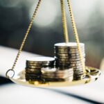 Coins stack with balance scale. Money management, financial plan, time value of money, business idea and Creative ideas for saving money concept.