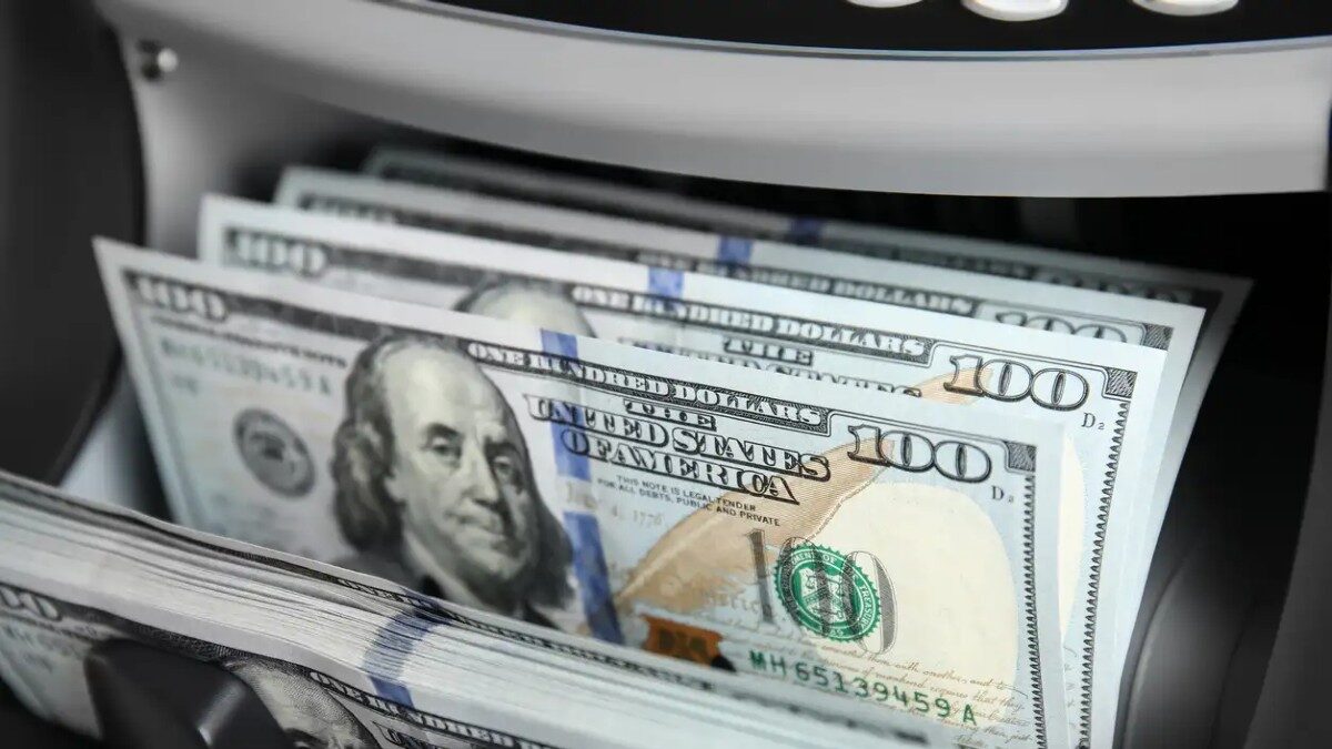 Modern electronic bill counter with money, closeup