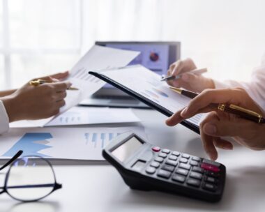 Team of Business people working at workplace with tablet and document, doing planning analyzing Tax financial report, business plan investment, finance analysis Economic business discussions.