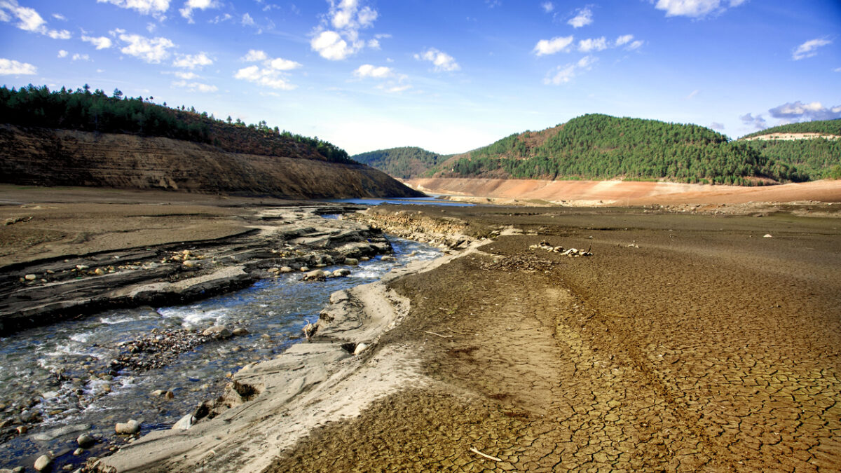 A drinking water dam that has been drained due to drought and unconscious use of water
