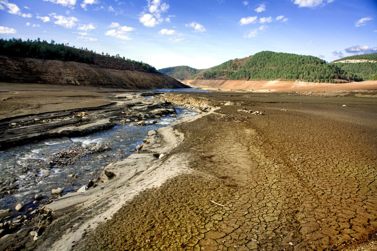 A drinking water dam that has been drained due to drought and unconscious use of water