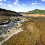 A drinking water dam that has been drained due to drought and unconscious use of water