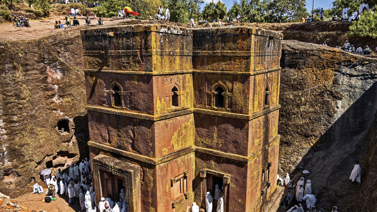 Lalibela, Ethiopia - Jan 06, 2023: Pilgrims gathered for Christmas church services (according to the the Ethiopian calendar ) at the Rock-Hewn Church of Saint George (Biete Ghiorgis), the best known of the the eleven monolithic churches of Lalibela .