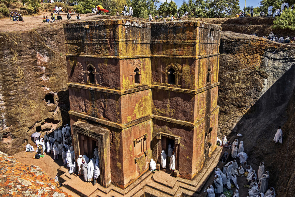 Lalibela, Ethiopia - Jan 06, 2023: Pilgrims gathered for Christmas church services (according to the the Ethiopian calendar ) at the Rock-Hewn Church of Saint George (Biete Ghiorgis), the best known of the the eleven monolithic churches of Lalibela .