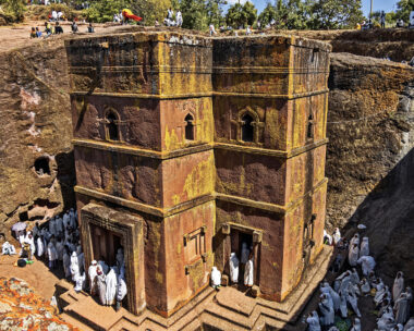 Lalibela, Ethiopia - Jan 06, 2023: Pilgrims gathered for Christmas church services (according to the the Ethiopian calendar ) at the Rock-Hewn Church of Saint George (Biete Ghiorgis), the best known of the the eleven monolithic churches of Lalibela .