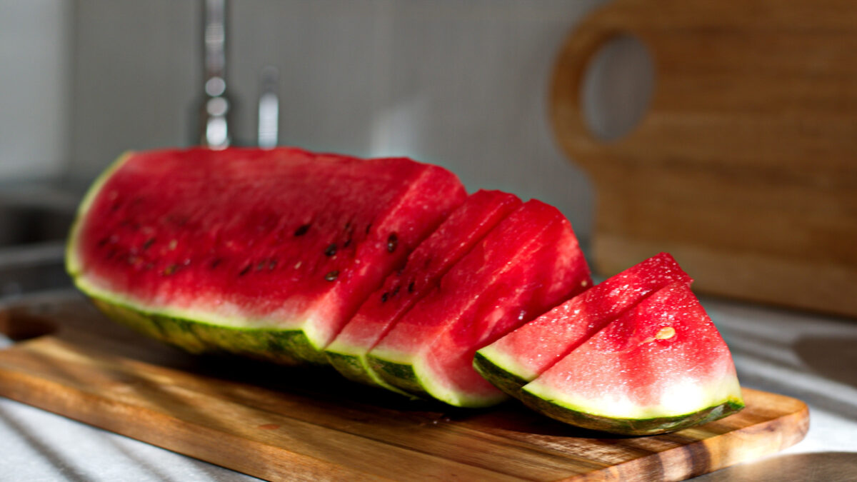 Piece of watermelon sliced on cutting board