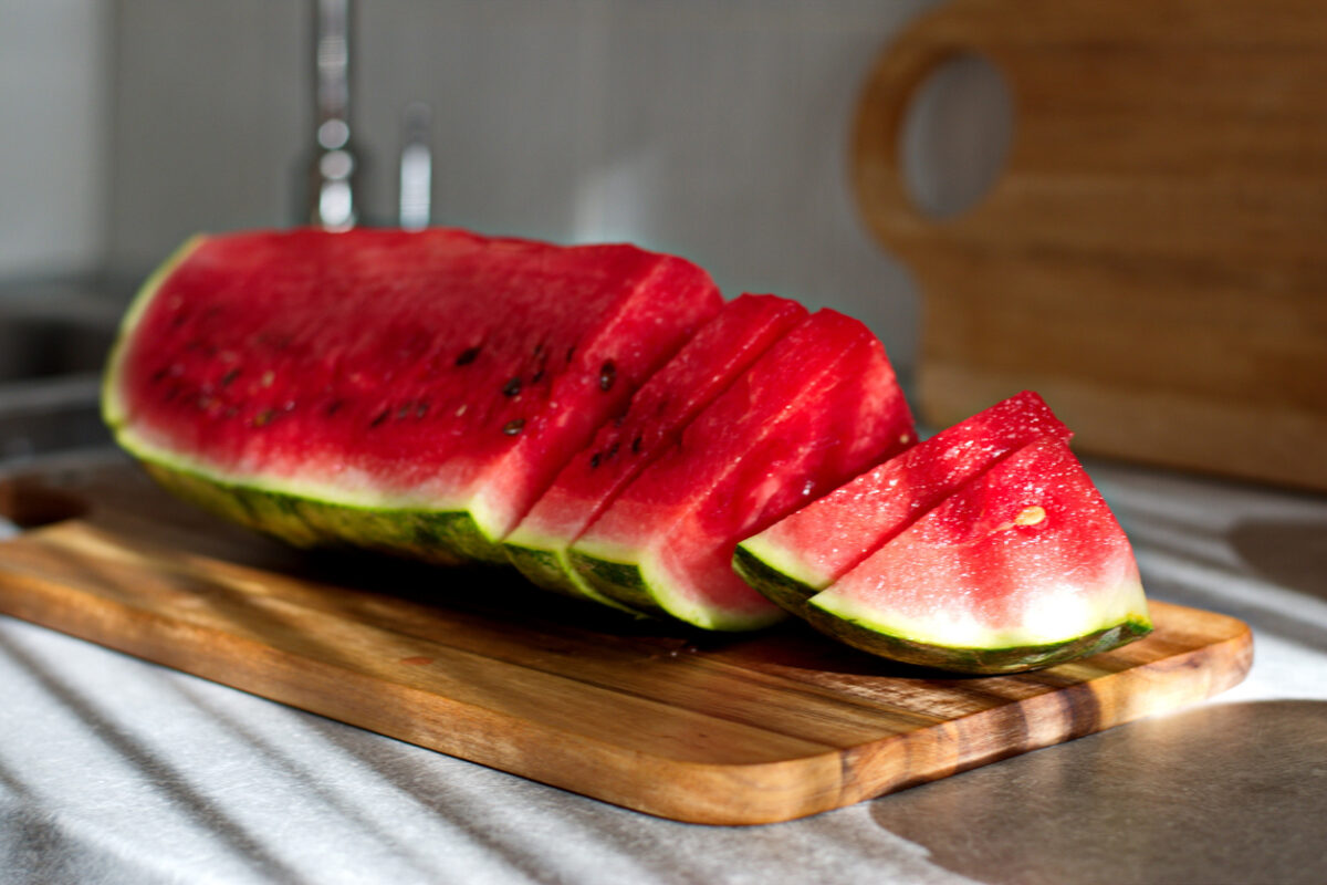 Piece of watermelon sliced on cutting board