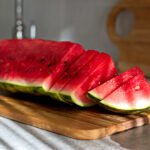 Piece of watermelon sliced on cutting board